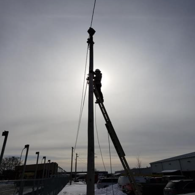 Technician Working on A Ladder